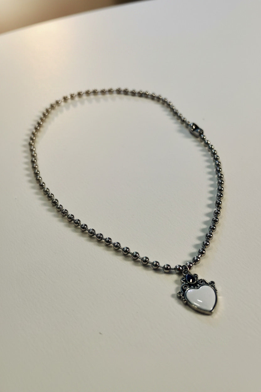 Necklace with a heart-shaped pendant on a light gray background