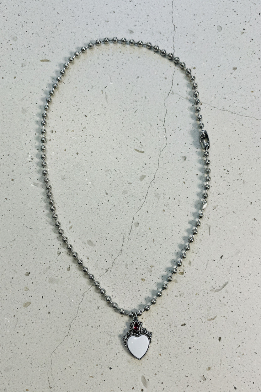Necklace with a heart-shaped pendant on a light gray background