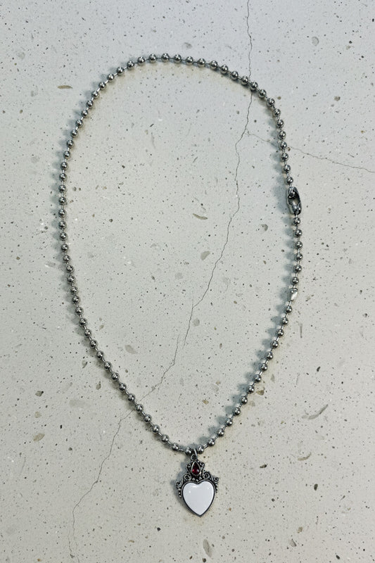 Necklace with a heart-shaped pendant on a light gray background