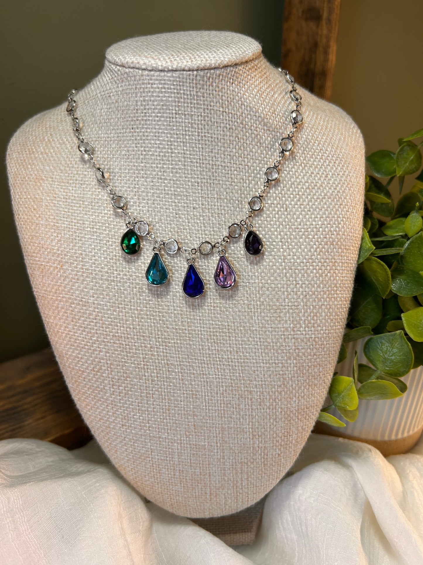 Bejeweled necklace with a continuous gem chain with 5 multicolor teardrops